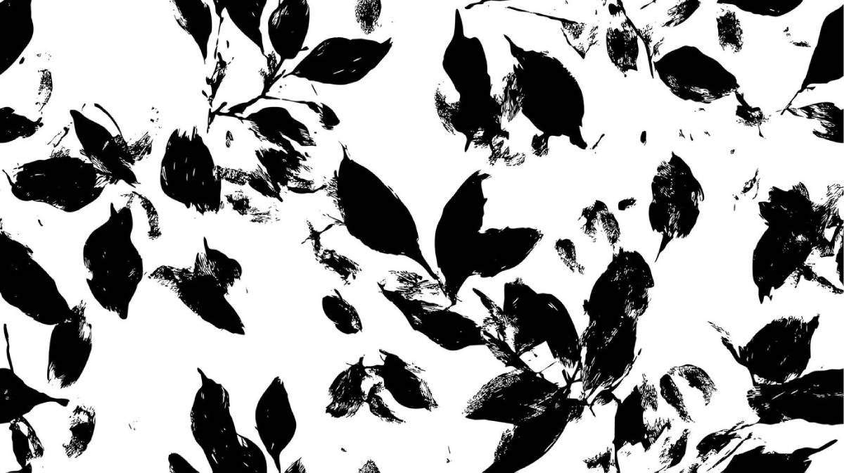 Black ink blots and leaf patterns scattered across a white background in an abstract design.