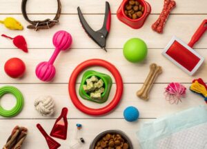 Various dog toys and grooming supplies spread across a wooden surface.